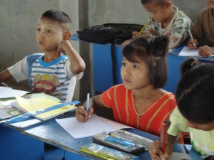 A young male and female student in a migrant learning center classroom