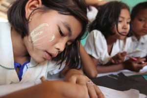 Girls do schoolwork in classroom